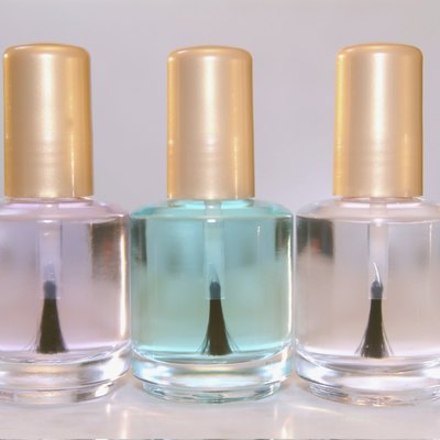 Close-up of three bottles of clear nail polish