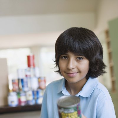 Boy holding canned food for food drive