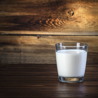glass of milk on wooden background