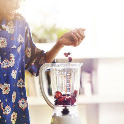Woman making a smoothie at home.