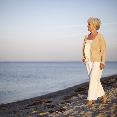 Relaxed old lady strolling on the beach