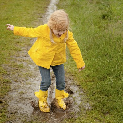 Girl Jumping in Mud Puddle