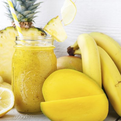 Fresh organic yellow smoothie with banana, apple, mango, pineapple