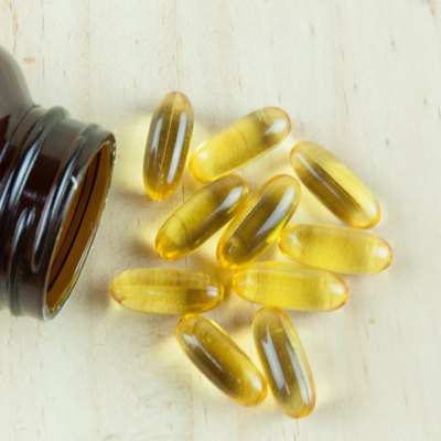 Fish Oil Arranged on wooden background with bottle laying down