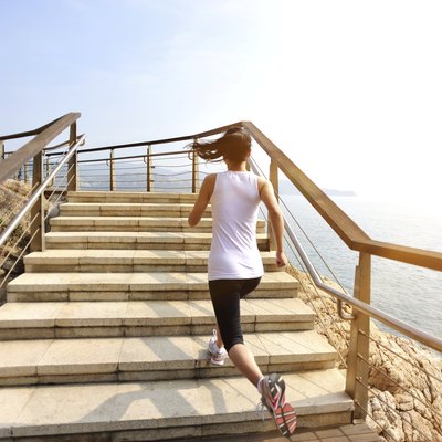 healthy lifestyle asian woman running at stone stairs seaside