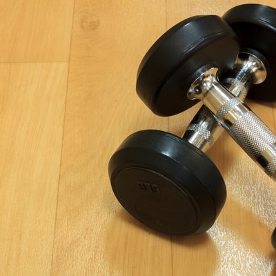 Dumbbells on the wood background.