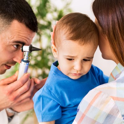 Otolaryngologist examining a kid ear