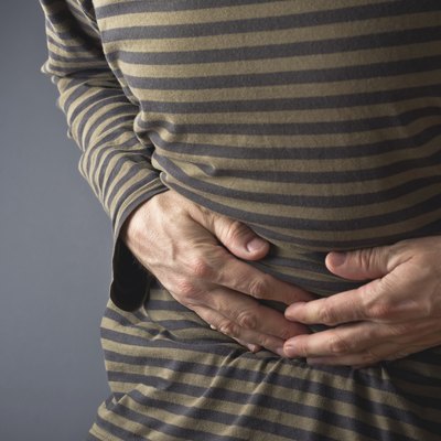 Abdominal Pain. Man holds his stomach and has hurt