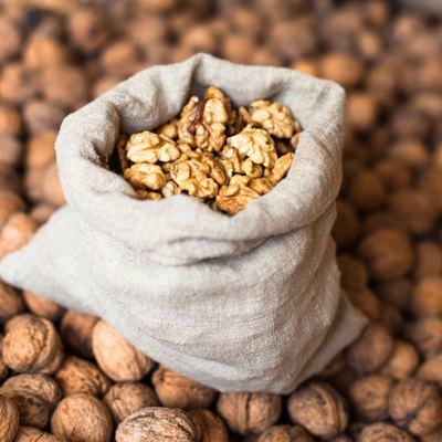 Walnuts kernels in the sack on the pile of walnuts