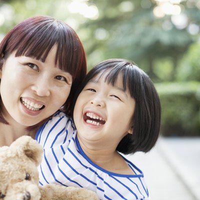 Mother and Daughter Embracing and Laughing