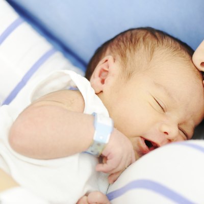 Woman holding her newborn baby at hospital