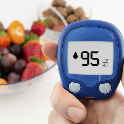 Hand holding meter. Diabetes doing glucose level test.
