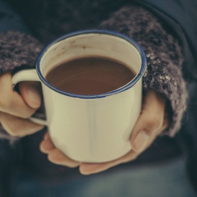 Hands holding a cup of hot chocolate in winter