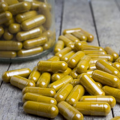 herbal capsules drug on wood board