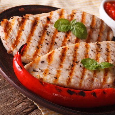 Grilled chicken breast and chili pepper on a plate horizontal