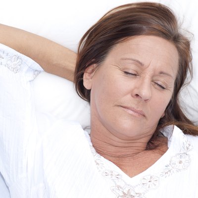 Relaxed mature woman asleep in bed