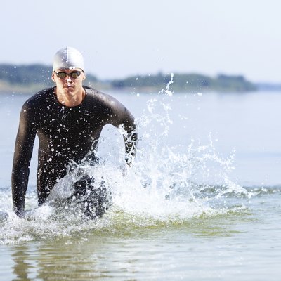 Triathlete running out of the water