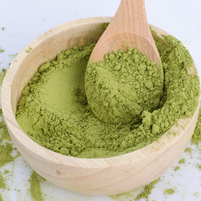 green powder heap isolated on white background