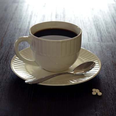 Coffee, white mug, saucer, teaspoon, sugar on table 1