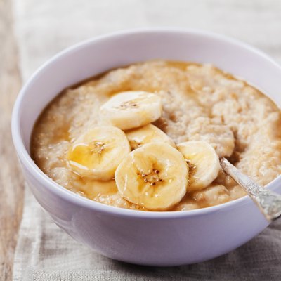 Bowl of oatmeal porridge with banana and caramel sauce
