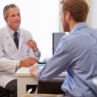 Male Patient Having Consultation With Doctor In Office