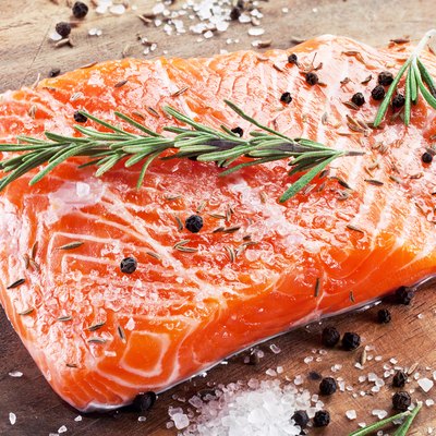 Salmon filet on a wooden carving board.