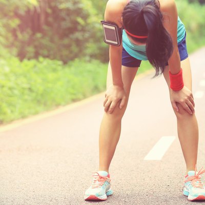 tired woman runner taking a rest after running hard