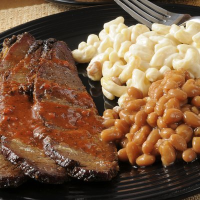 Closeup up of beef brisket with baked beans