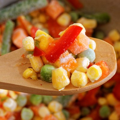 Closeup spoon with frozen mixed vegetables