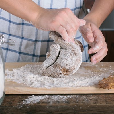 Girl's hands kneading dough for gingerbread.