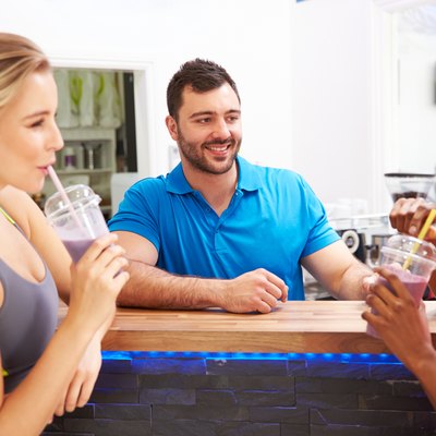 People drinking protein shakes at the fitness bar in gym