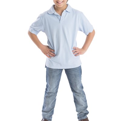 Boy Standing With Hands On Hip Against White Background