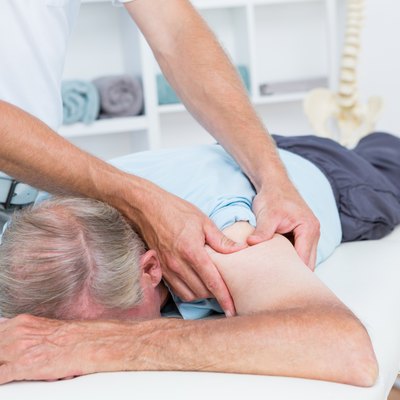 Physiotherapist doing shoulder massage to his patient