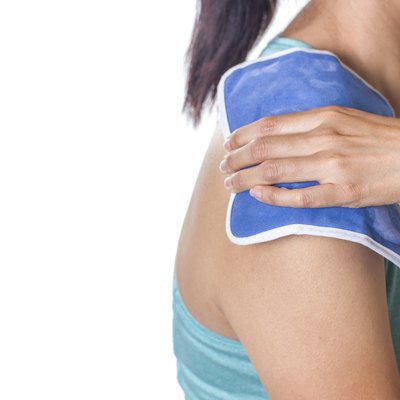 woman putting an ice pack on her shoulder pain