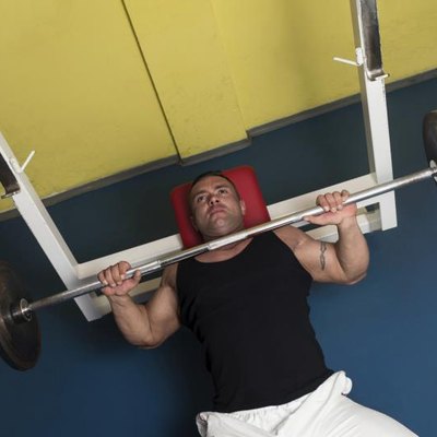 Bodybuilder In Gym Exercising On The Bench Press
