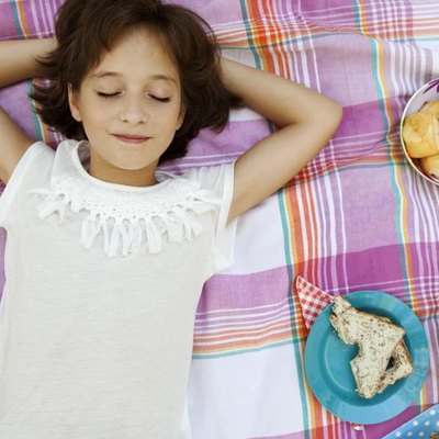 Overhead portrait of child girl with picnic
