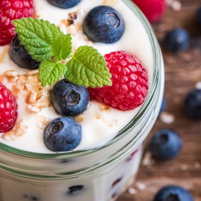 Detail of Yogurt with Fresh Berries on Woden Table