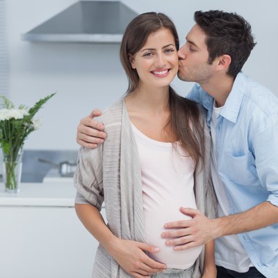 Man kissing his pregnant wife