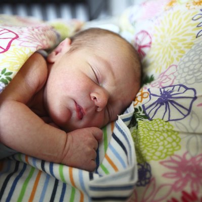 Infant sleeping on a bed