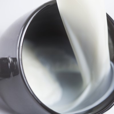 Milk flowing into a mug