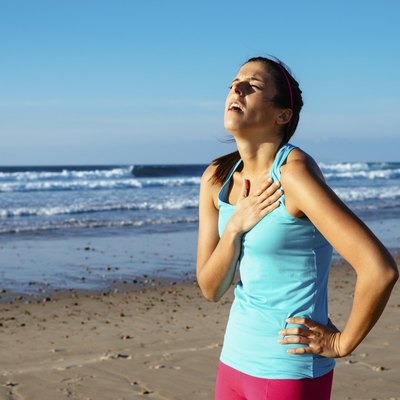 Exhausted female runner suffering angina pectoris