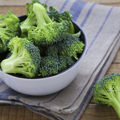 fresh broccoli in a bowl on rustic table