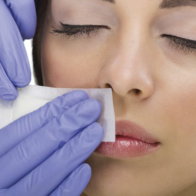 woman reciving facial epilation