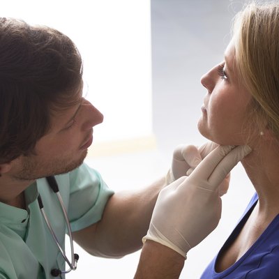 GP examining woman