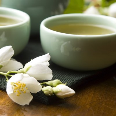 Green tea with jasmine in cup and teapot