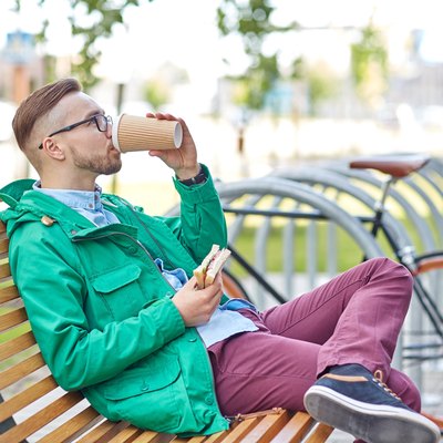 happy young hipster man with coffee and sandwich