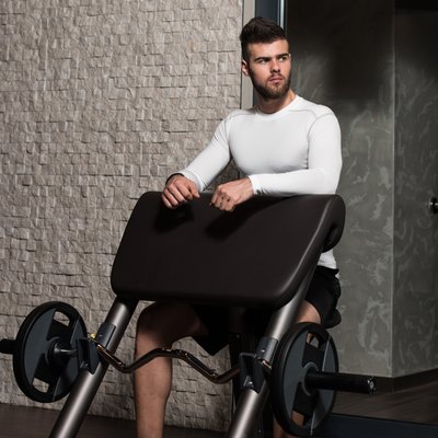 Male Athlete Doing Heavy Weight Exercise For Biceps