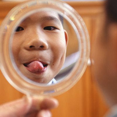 Boy Sticking Tongue Out at Mirror