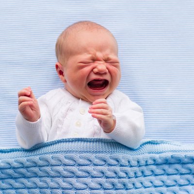 Newborn baby boy on a blue blanket