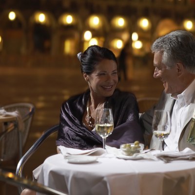 Italy, Venice, couple at restaurant table at night, outdoors